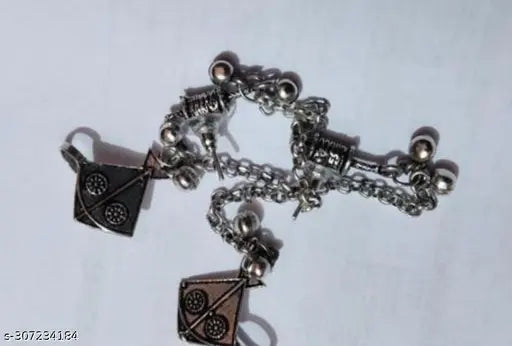 Silver bracelet with various charms on a white background